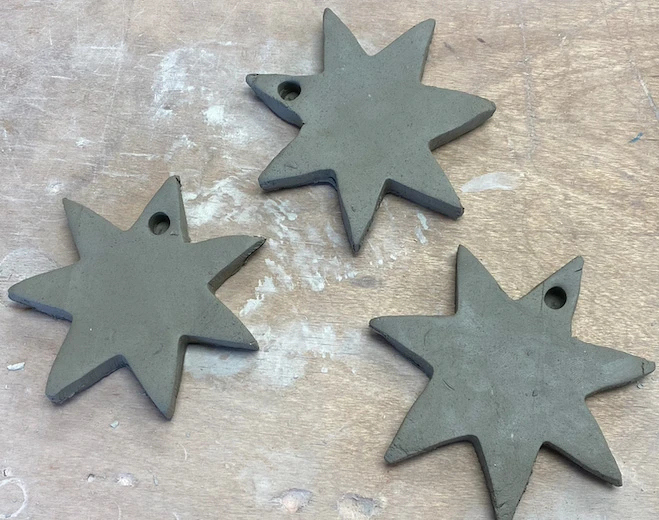 Kids paint ceramic Christmas decorations